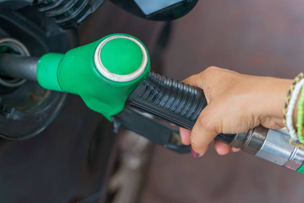 istock Unrecognizable woman putting petrol in her car 1370133049