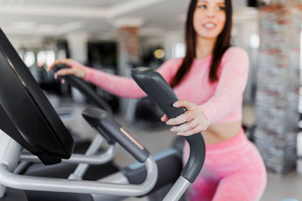 istock Young woman jogging on a treadmill in a gym 1370133963