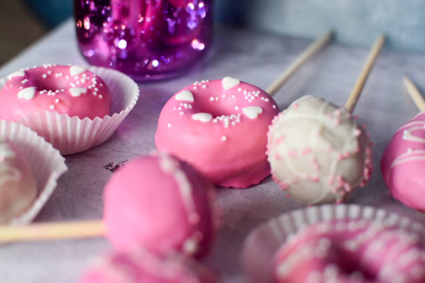 istock Pink and white donuts and chocolate pops 1370140161