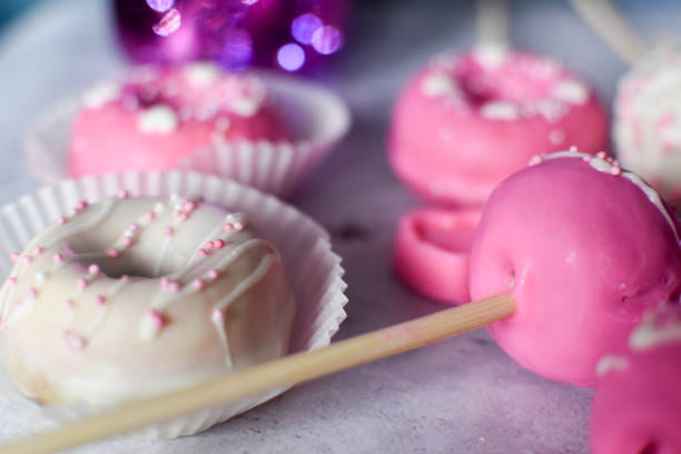 istock Pink and white donuts and chocolate pops 1370140180