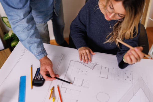 istock Private professor helping young female student with architecture exam 1370143053