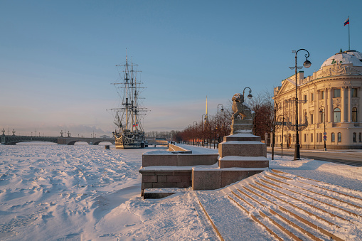 Chinese mythological guardian lion when descending to the Neva River on Petrovskaya Embankment on a sunny winter day, St. Petersburg, Russia