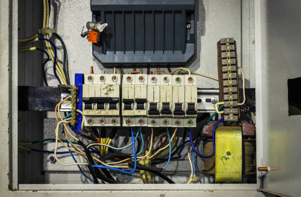 Cable chaos in electric control panel close-up. Tangled wires. Circuit breakers stock photo