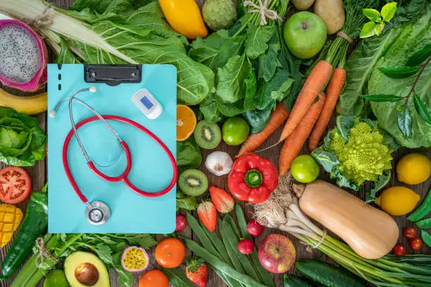 Photo of Fruits and vegetables and cardiovascular health concept with medical instruments