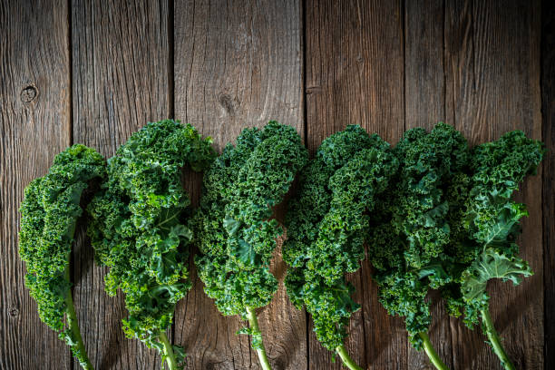 Kale crucifer leaf vegetable on rustic wood board curly kale copy space