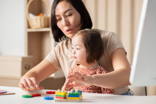 istock teacher working with a child with down syndrome 1370150740