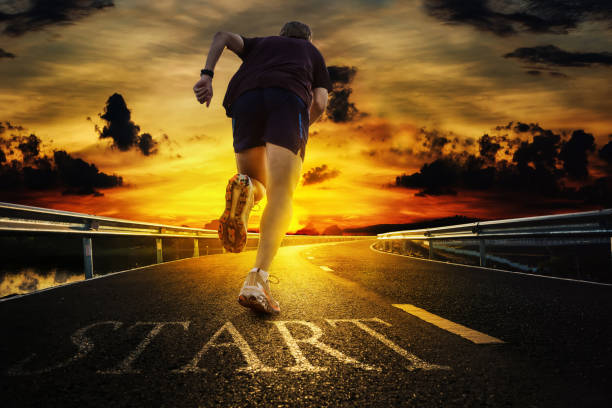 istock Runners start running from the starting point against sunrise 1370151715