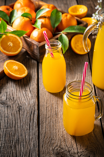 Freshness orange juice in clear glass,Orange and slice orange on white background.