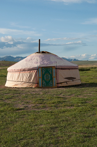 Mongolian traditional house named ger or yurt, in a beautiful landscape. Blue sky. Rural area near Kharakhorum, Mongolia. These houses are now used to host tourists.\