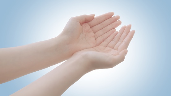 Female beauty hands showing palms top view in giving or receiving gesture. Isolated clean background showing holding or offering pose revealing product showcase and copy space. Young woman white Skin.