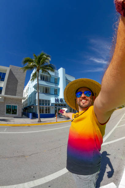 POV Point of view shot of a young travel male enjoying his vacations while holding his passport, a map and a boarding pass airline ticket in front of Ocean Drive, Miami, USA. POV Point of view shot of a young latin travel male enjoying his vacations while holding his passport, a map and a boarding pass airline ticket in front of Ocean Drive, South Beach, Miami Beach, Miami, South Florida, United States of America
The picture was taken at the famous and touristic Art Deco District. Shooting from a personal perspective in an exotic tropical beach travel holidays.
Travel Concept. 1 hotel south beach stock pictures, royalty-free photos & images