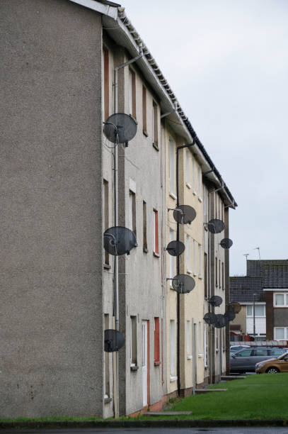 istock satellite dish in group on wall of council house 1370162848