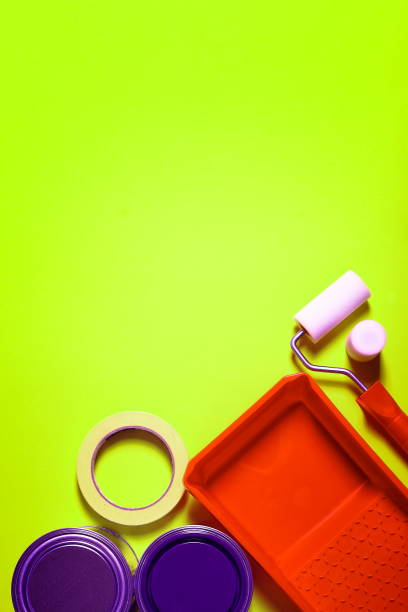 istock Painter's utensils, tape and paint cans on the floor. 1370162934
