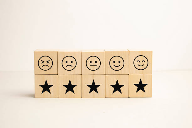 istock emotion face and Star symbol blocks on table background. Service rating, ranking, customer review, satisfaction, evaluation and feedback concept 1370165267
