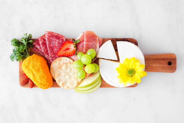 istock Spring or Easter charcuterie board over white marble background. Above view. 1370167842