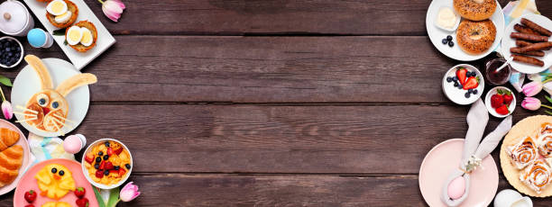 istock Fun Easter breakfast or brunch double border. Overhead view on a dark wood banner background. 1370168502