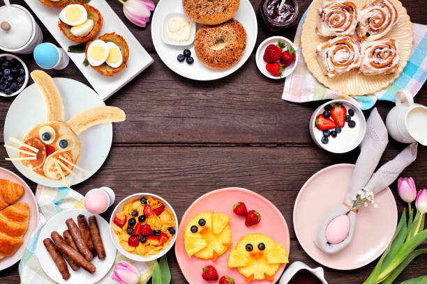 istock Fun Easter breakfast or brunch frame. Above view on a dark wood background. 1370168506
