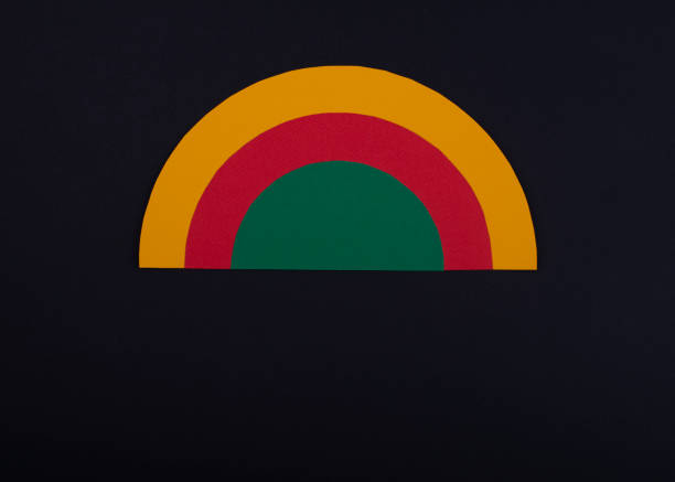 istock Black history month colors rainbow. Paper cut abstract composition on dark background. 1370168581