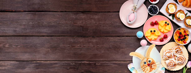 istock Fun Easter breakfast or brunch side border. Top down view on a dark wood banner background. 1370168638