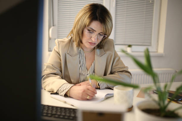 istock Woman working from home, handwriting a document. stock photo 1370168645