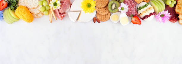 Spring or Easter charcuterie top border against a white marble banner background