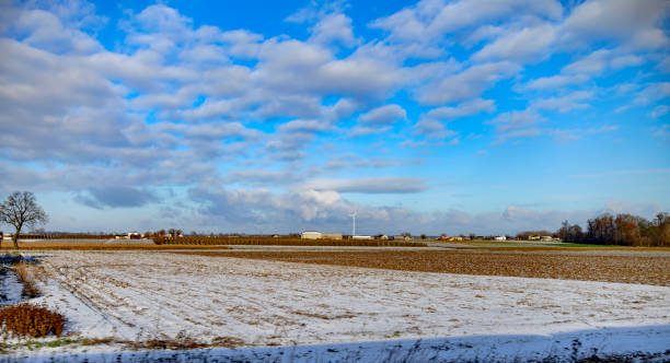 istock Winter field. On the horizon are visible wind power generators. 1370169886