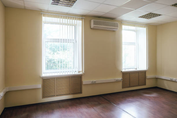 istock Not equipped empty office room with bright windows and air conditioner. 1370170118