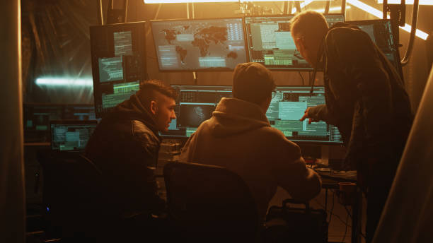 istock Team of hackers in dark room 1370170150