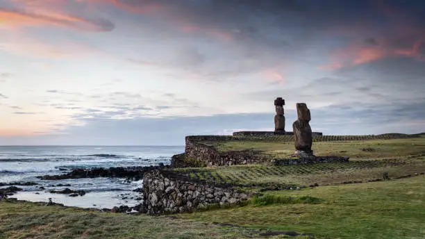 Easter Island Hanga Roa colorful twilight - sunset Panorama. Ahu Ko Te Riku Moai close to the Tahai Ceremonial Complex at the Coast of Hanga Roa, Rapa Nui National Park, Easter Island - Isla de Pascua, Chilenean Polynesia, Chile