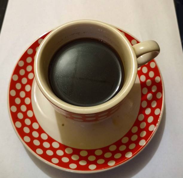istock Cafe with white glasses with red polka dots on white background 1370173789