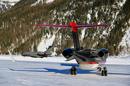 Private jets and aircrafts in the airport of Engadine St Moritz in winter time