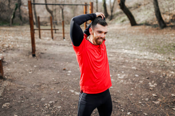 istock Runner doing stretching in the public park at the morning 1370176361