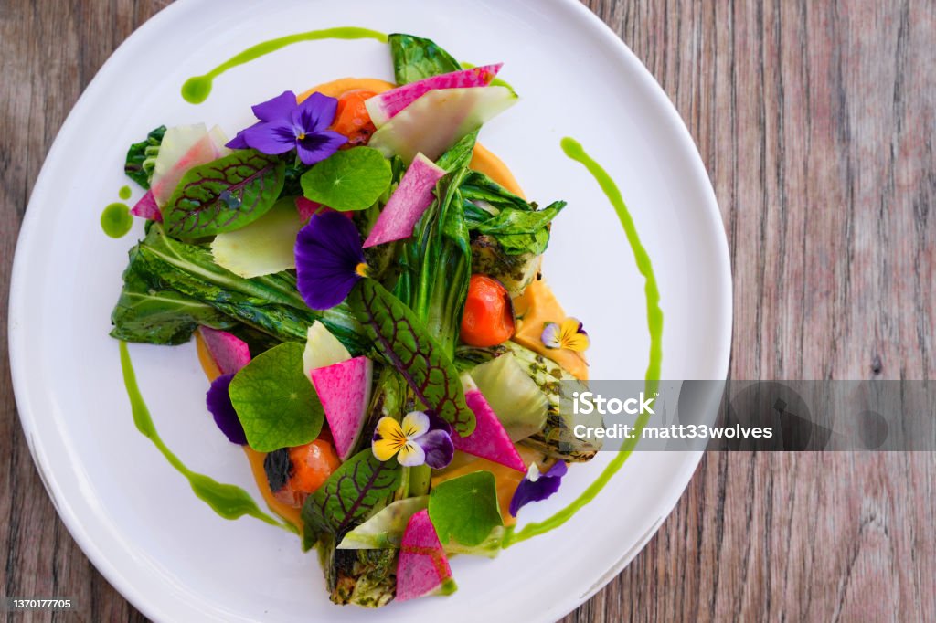 Colorful greens farm to table salad mixing beautiful presentation with fresh ingredients and vibrant colors. Farm-To-Table Stock Photo