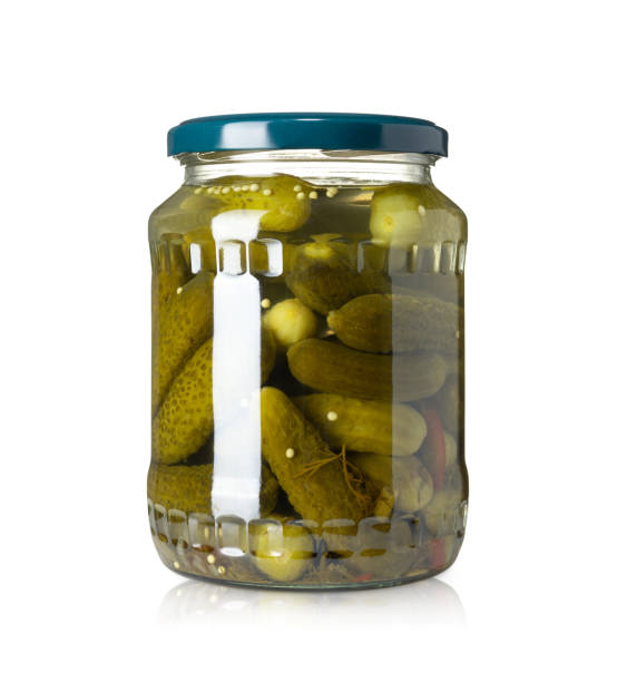 istock Cucumbers in glass jar isolated on white background. Pickles cucumbers isolated. 1370180301