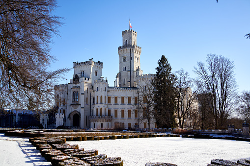 Hluboka nad Vltavou, Czech Republic - January 21, 2022: Neo-gothic castle in South Bohemia in winter under snow