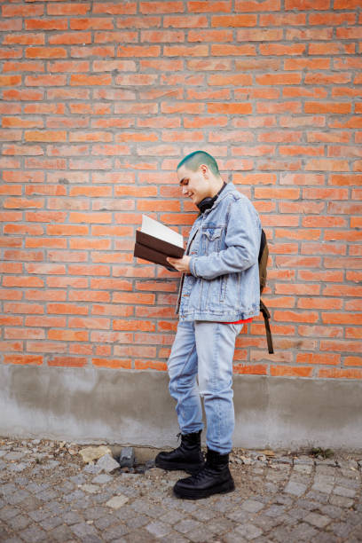 Male student with blue hair learning outdoors