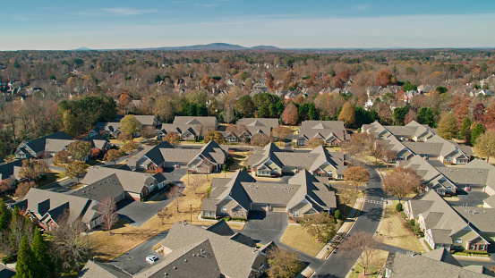 Aerial shot of suburban streets in Alpharetta, a city to the north of Atlanta, Georgia, on a sunny day in Fall.