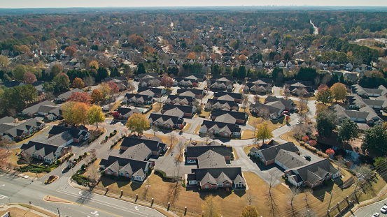 Aerial shot of suburban streets in Alpharetta, a city to the north of Atlanta, Georgia, on a sunny day in Fall.