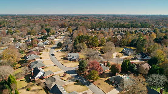Aerial shot of residential streets in Alpharetta, a city to the north of Atlanta, Georgia, on a sunny day in Fall.
