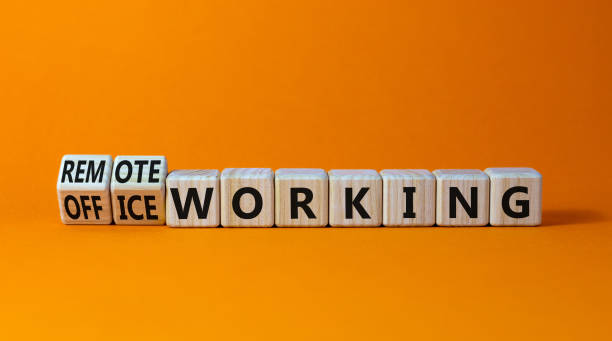 istock Office or remote working symbol. Turned wooden cubes and changed words 'remote working' to 'office working'. Beautiful orange background. Business, office or remote working concept, copy space. 1370185657