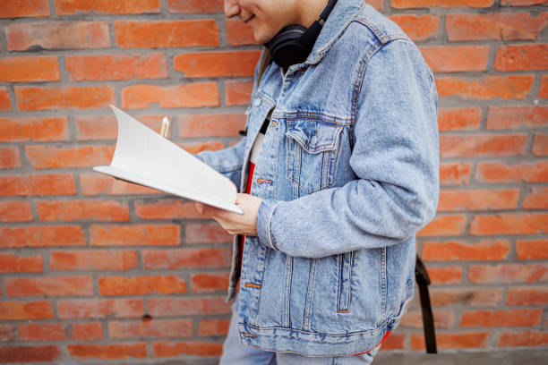 Male student with blue hair learning outdoors