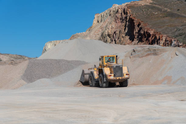 Belt conveyors, piles of rubble and Wheel loader in Gravel Quarryin sunny day