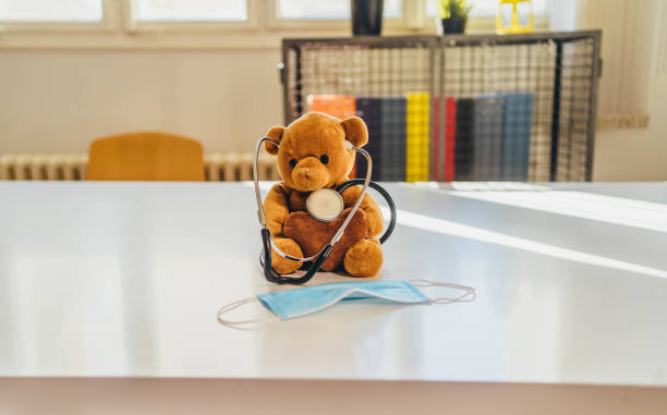 Teddy bear with stethoscope and protective face mask