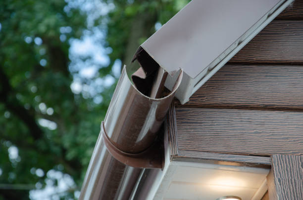 istock Gutter with downpipe on the roof of a house. 1370191295