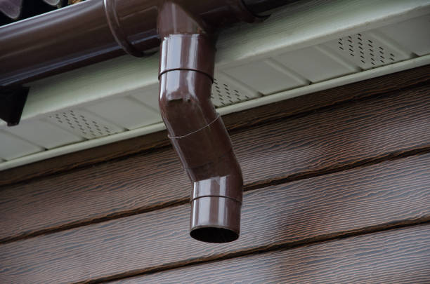 istock Gutter with downpipe on the roof of a house. 1370191302