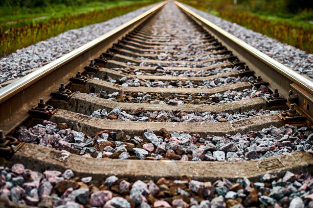 istock Railway track line going into distance, railroad train track with crushed stone, two parallel rails 1370192751
