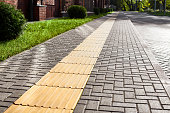 Yellow tactile paving on walkway, tactile ground surface indicators for blind and visually impaired