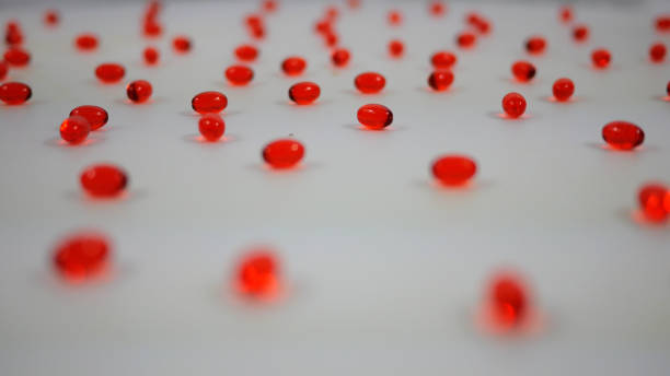 istock Red Clear Stool Softener Pills Spinning over White Background 1370194095