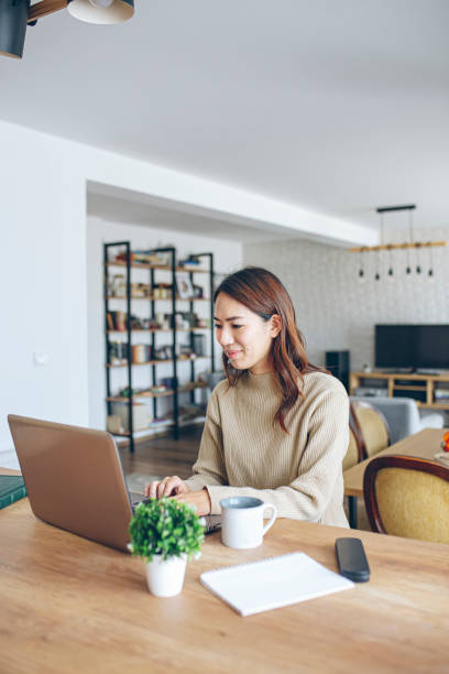 istock Smiling young female entrepreneur working on a laptop 1370194867