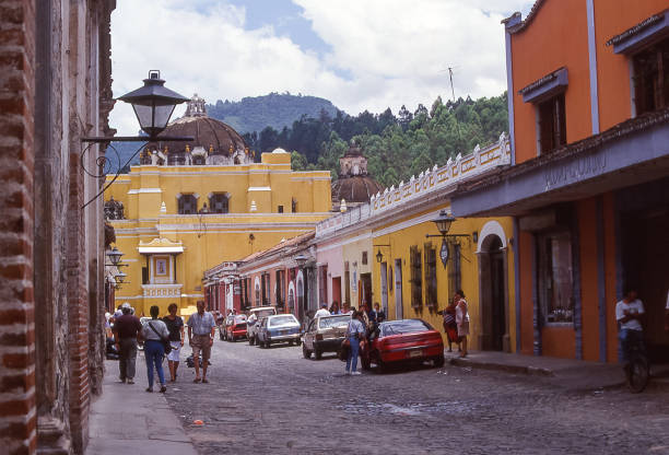 Antigua, Guatemala - aug 17, 1988: street of Antigua, the ancient capital of Guatemala, with low colonial-style houses, due to frequent strong earthquakes and volcanic eruptions.